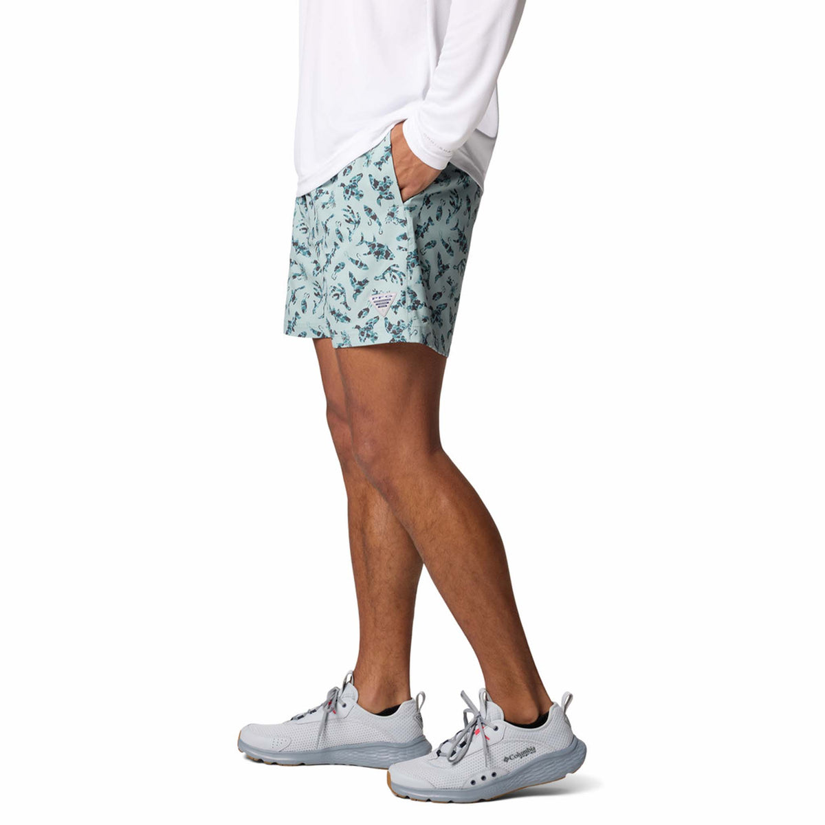 Side view - Columbia Sportswear 6&quot; Printed Rambler Men&#39;s swim trunks, color aqua blue with silhouettes of fishing related icons.  Featuring Omni-Shade™ UPF 50 these shorts guard against skin damage. Created for all-day comfort and breathability using fast dry fabric. Hand pockets for personal items are built in.