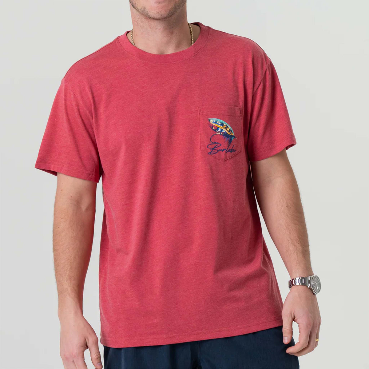 Front view of man wearing Burlebo short sleeve Big Fly t-shirt in heather crimson.  The design features a brightly colored fly-fishing lure with Burlebo&#39;s logo under printed on the left chest pocket.   Made from a preshrunk blend of 50% Ring-Spun Cotton and 50% Polyester, this tee offers the perfect combination of softness and durability.