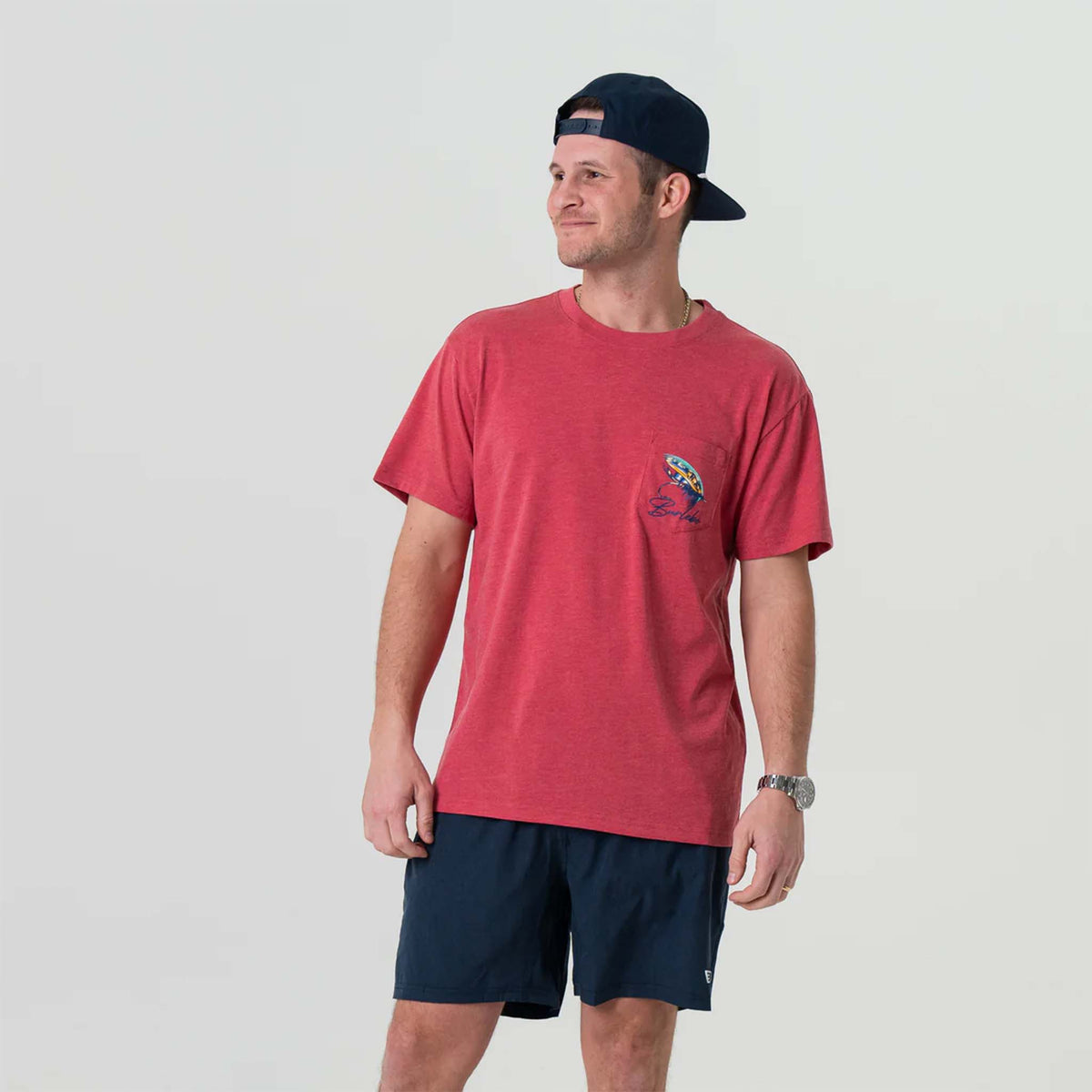Front view of man wearing Burlebo short sleeve Big Fly t-shirt in heather crimson.  The design features a brightly colored fly-fishing lure with Burlebo&#39;s logo under printed on the left chest pocket.   Made from a preshrunk blend of 50% Ring-Spun Cotton and 50% Polyester, this tee offers the perfect combination of softness and durability.