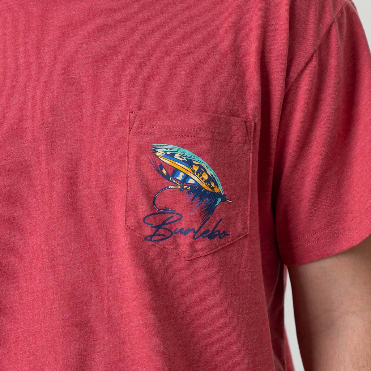 Close up Front view of man wearing Burlebo short sleeve Big Fly t-shirt in heather crimson.  The design features a brightly colored fly-fishing lure with Burlebo&#39;s logo under printed on the left chest pocket.   Made from a preshrunk blend of 50% Ring-Spun Cotton and 50% Polyester, this tee offers the perfect combination of softness and durability.