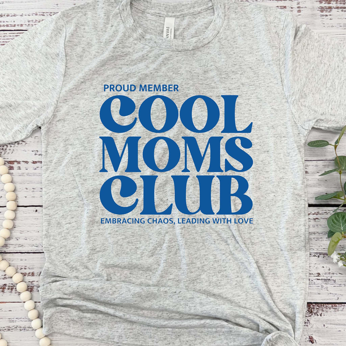 Grey short sleeve t-shirt with a screen-printed design that reads &#39;Cool Moms Club&#39; in bold, stylish lettering across the front.