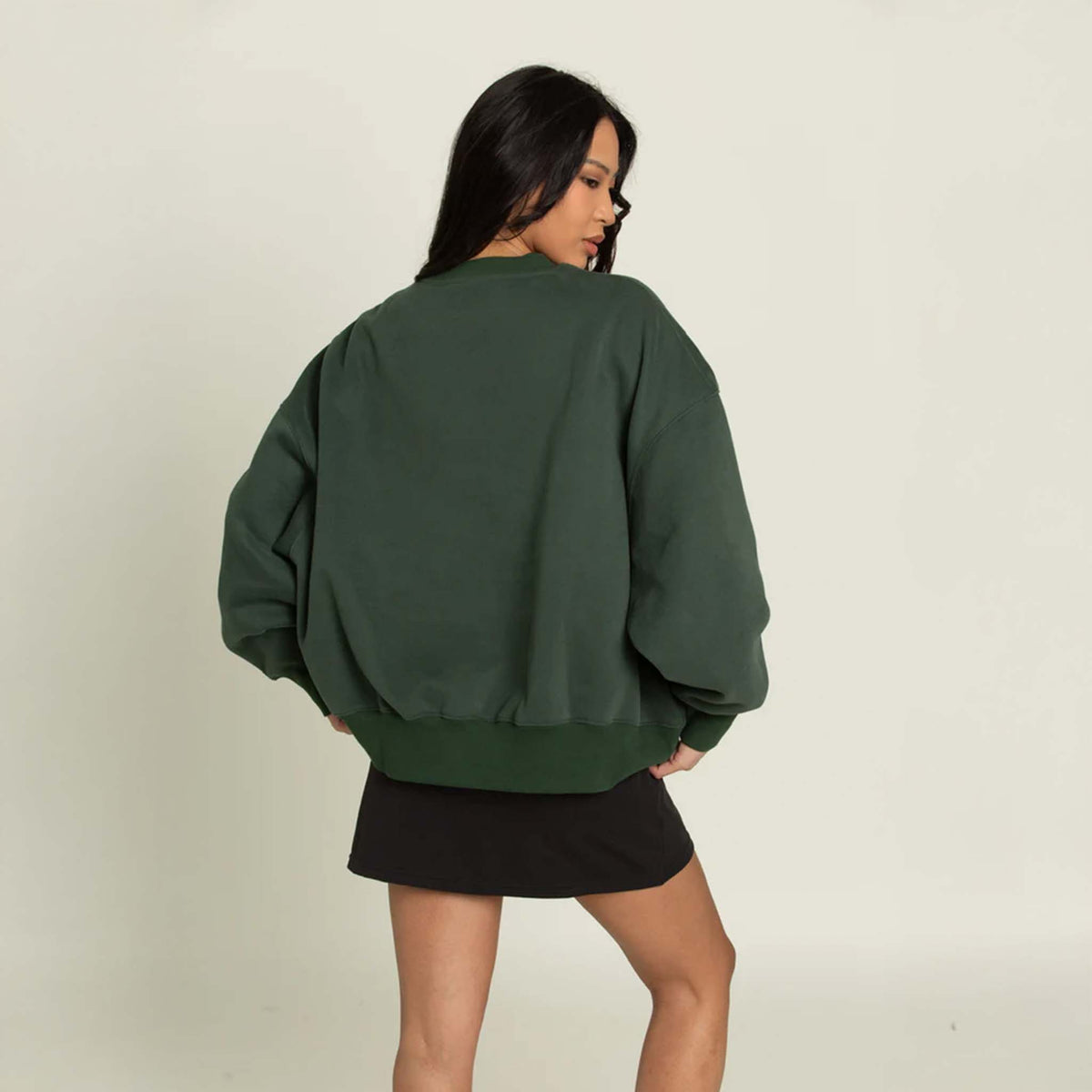 Back view of the Gold Hinge oversized crewneck sweatshirt showing a loose, draped silhouette with a ribbed hem and clean, unembellished back.