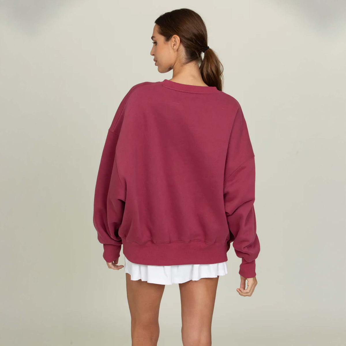 Back view of the Gold Hinge oversized crewneck sweatshirt showing a loose, draped silhouette with a ribbed hem and clean, unembellished back.