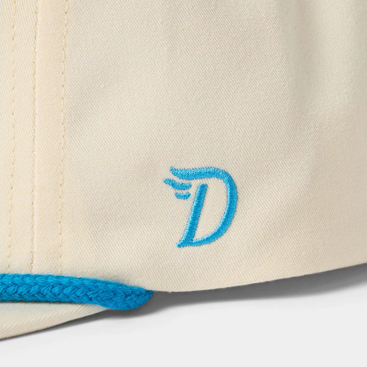 Close up of Duck Camp embroidered logo on the Crab Snapback hat by Duck Camp, color ivory.