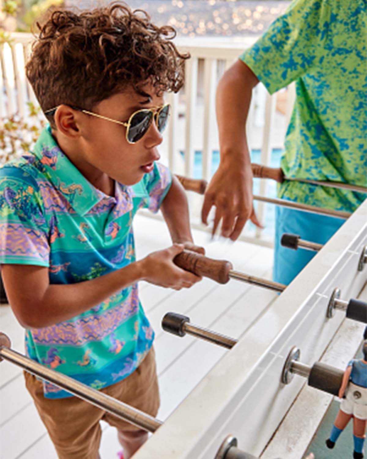 kid playing foosball