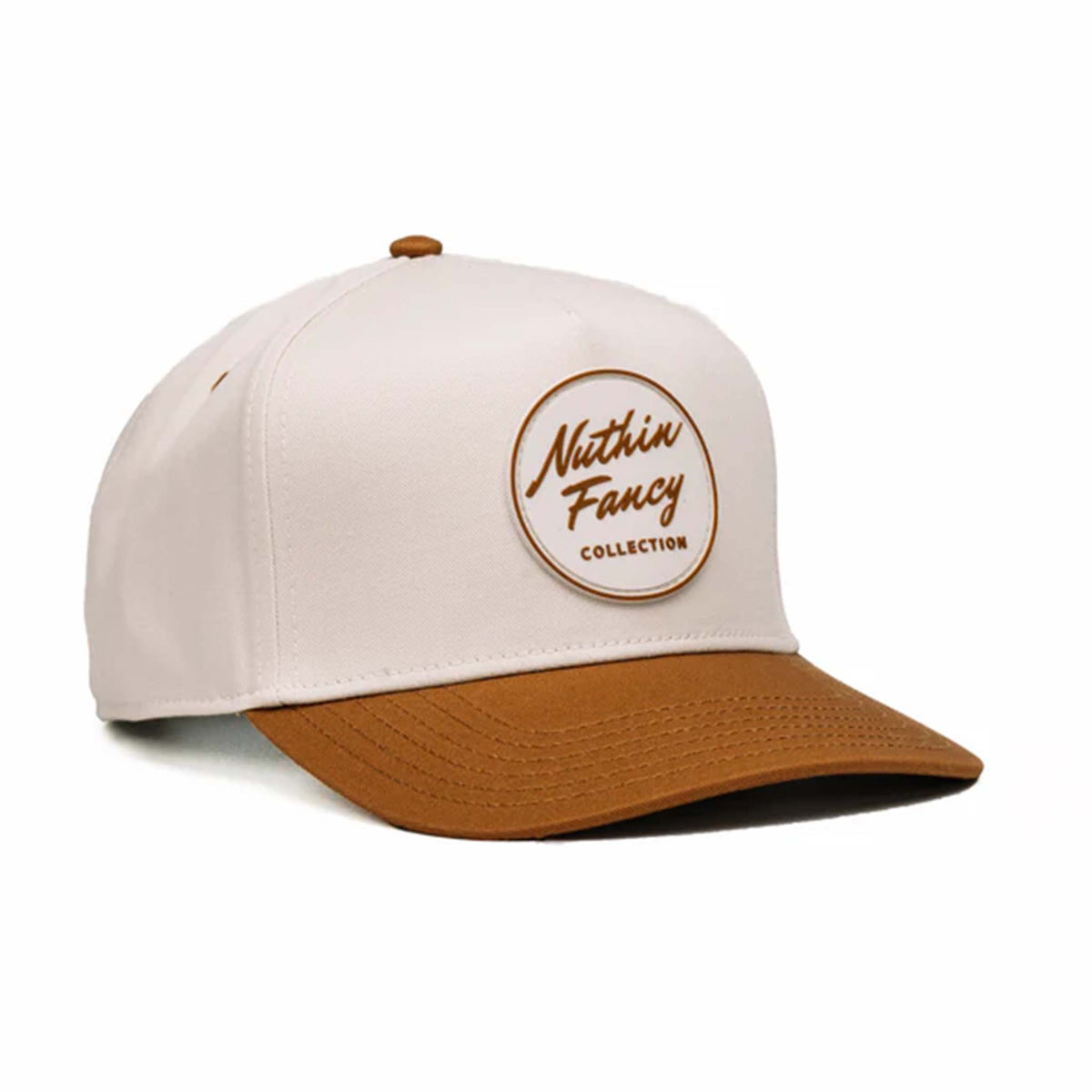 Two-toned 5-panel high crown trucker hat with an off-white front and rust-colored pre-curved bill. Features an off-white and rust rubber &#39;Nuthin’ Fancy&#39; patch on the front, rust mesh back panels, and an adjustable plastic snapback closure. One size fits most.