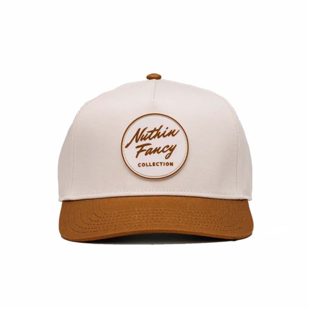 Two-toned 5-panel high crown trucker hat with an off-white front and rust-colored pre-curved bill. Features an off-white and rust rubber &#39;Nuthin’ Fancy&#39; patch on the front, rust mesh back panels, and an adjustable plastic snapback closure. One size fits most.
