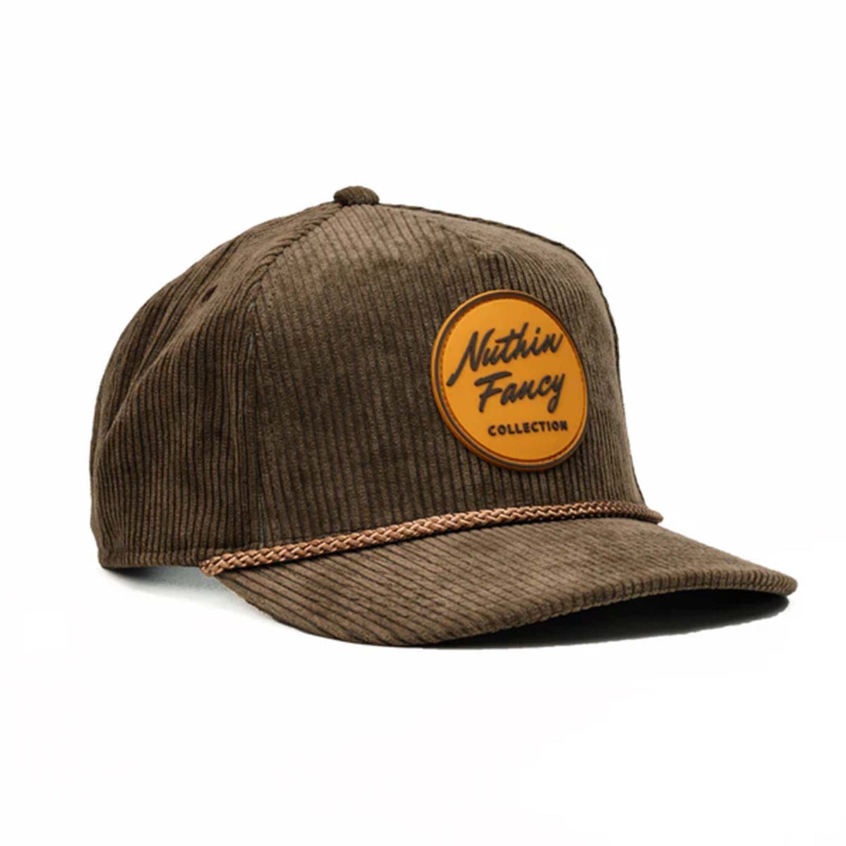 Tan corduroy snapback hat with a slightly curved bill and a brown and tan rubber &#39;Nuthin’ Fancy&#39; logo patch on the front. Features a decorative rope detail above the bill and an adjustable plastic snap closure. One size fits most (58 cm).