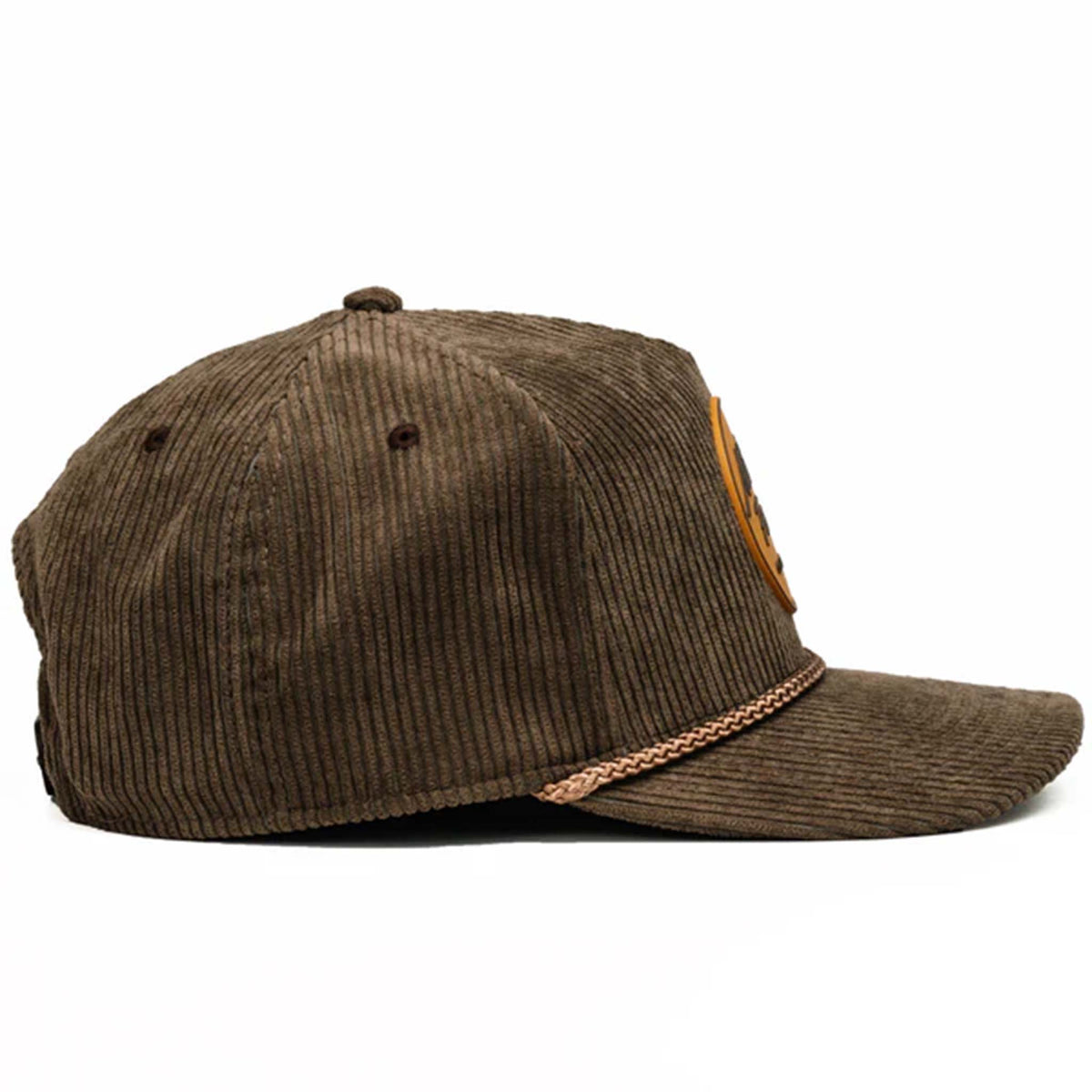 Tan corduroy snapback hat with a slightly curved bill and a brown and tan rubber &#39;Nuthin’ Fancy&#39; logo patch on the front. Features a decorative rope detail above the bill and an adjustable plastic snap closure. One size fits most (58 cm).