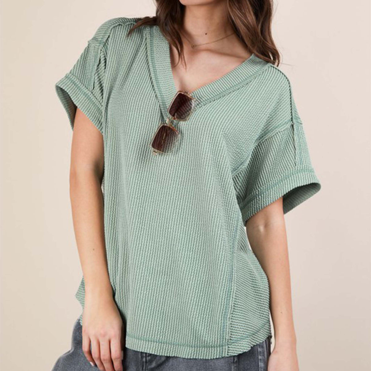 Front view of a woman wearing the Very J Ribbed V-Neck Short Sleeve Knit Top, color Sage, sizes S-L.
A versatile essential, this short-sleeve top features a soft ribbed knit fabric and a flattering V-neckline. Easy to dress up or down, it’s the perfect go-to for effortless everyday style!
Soft Two Tone Casual Comfy Ribbed Knit Top
V-Neck
Short Sleeve
Raw Edge Detail