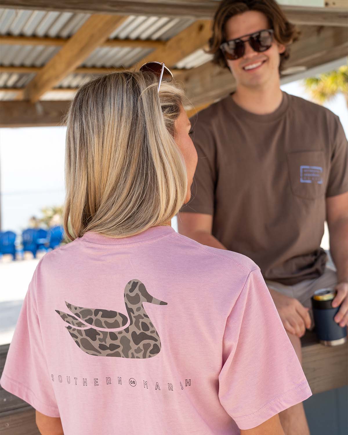 a girl having a conversation with a guy wearing southern march t-shirts