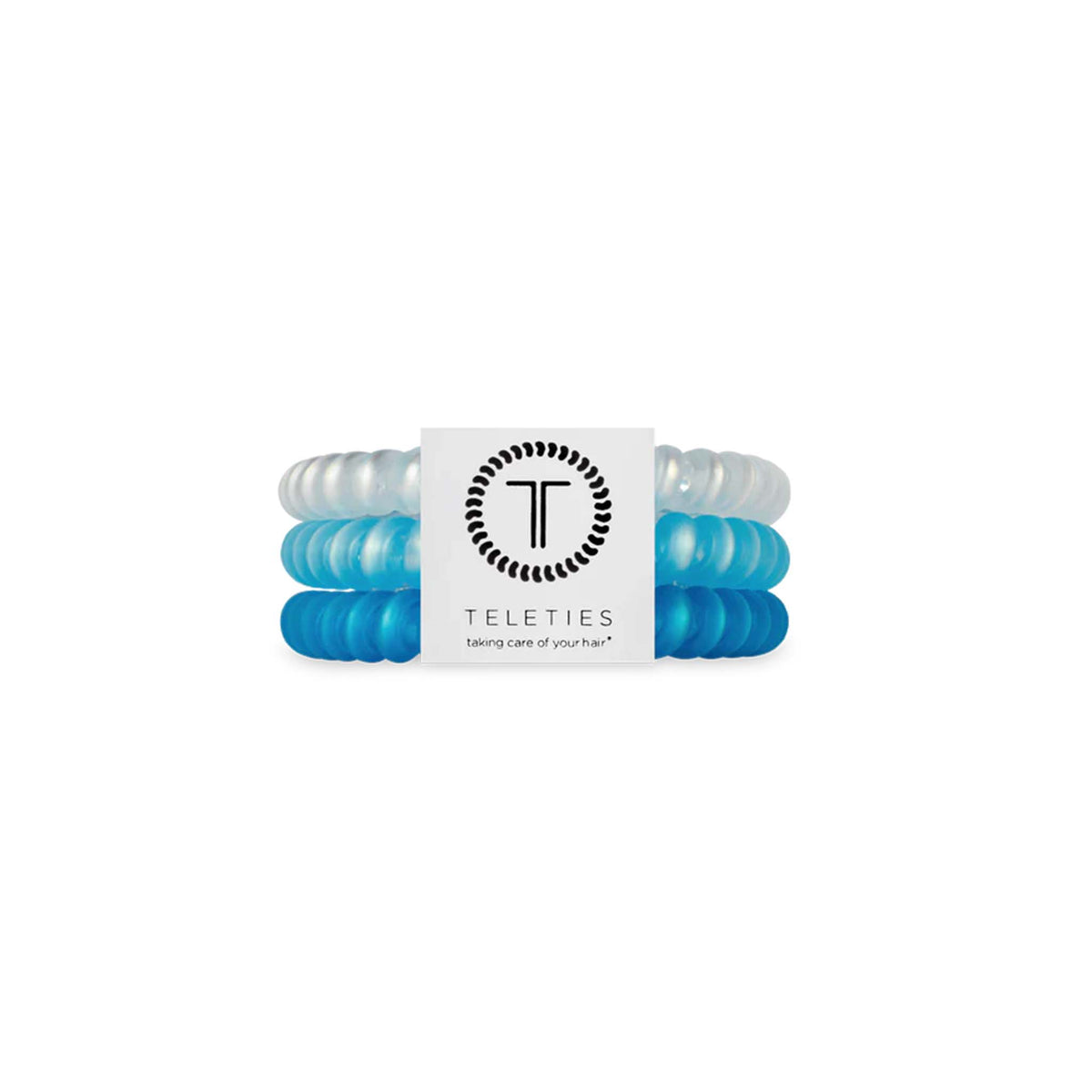 Three-pack of small TELETIES hair ties in the &#39;Blue Seas&#39; color set. Includes one white, one blue, and one light blue hair tie. Each tie has a coiled, telephone cord-style design that offers a strong yet gentle hold, ideal for all hair types.